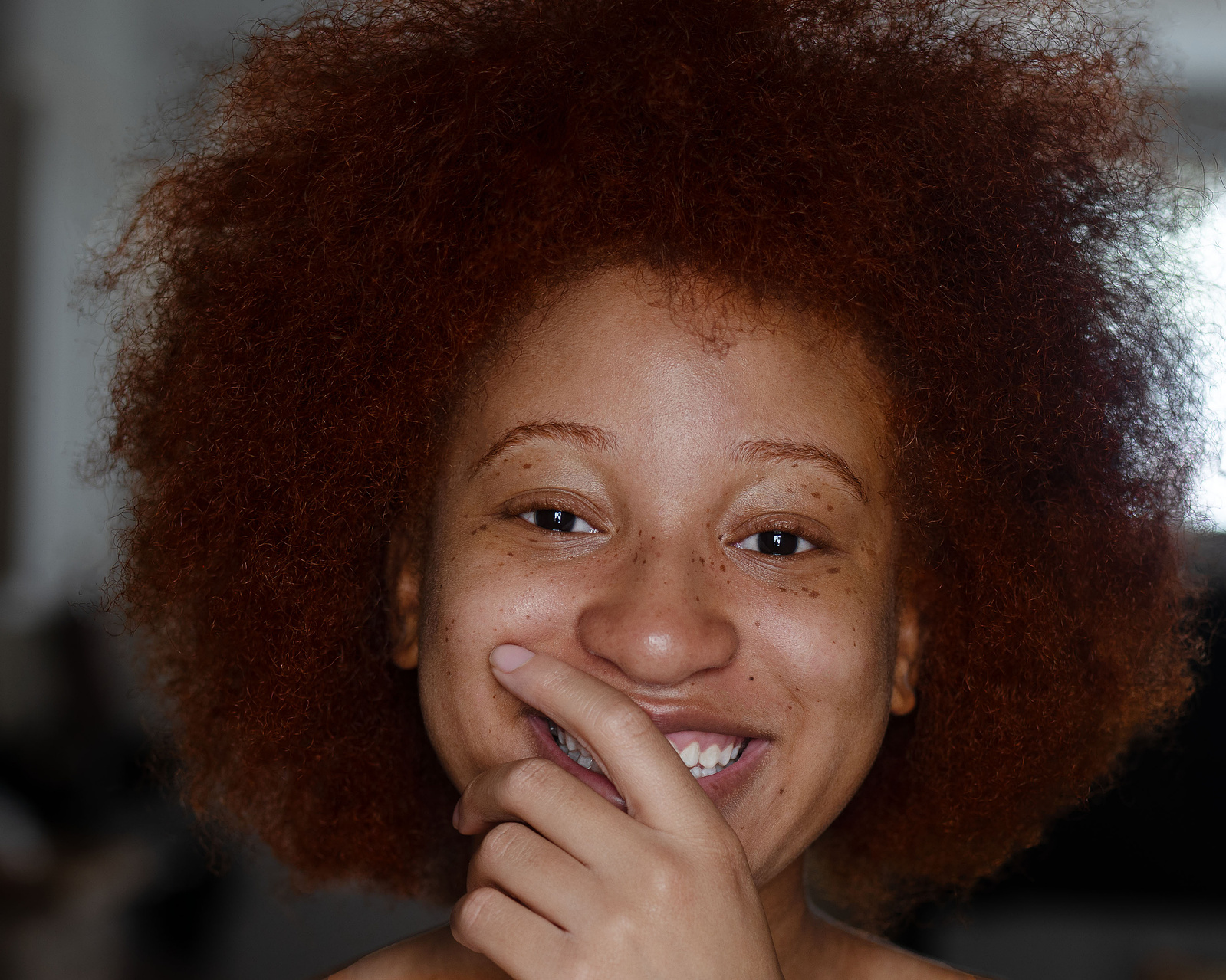 natural red hair woman with afro 