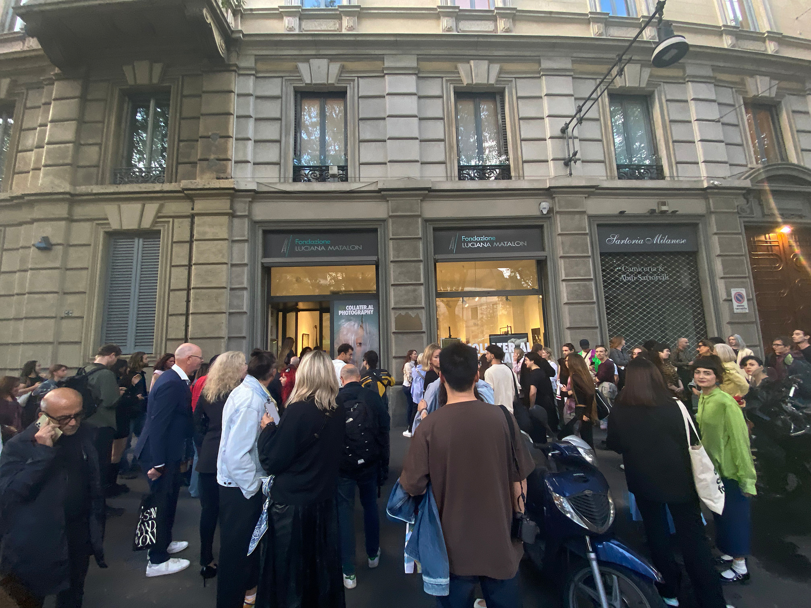 Crowd of art collectors and photographers standing outside an art gallery in Milan, Italy.
