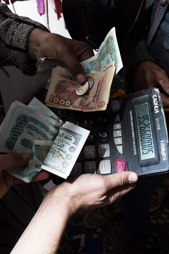 WESTERN SAHARA, MARKET OF SMARA.An everyday purchase at the market of Smara using moroccan dinars. Despite not having a currency of their own, Saharawi people have invented a local exchange rate in order to price their goods locally. 