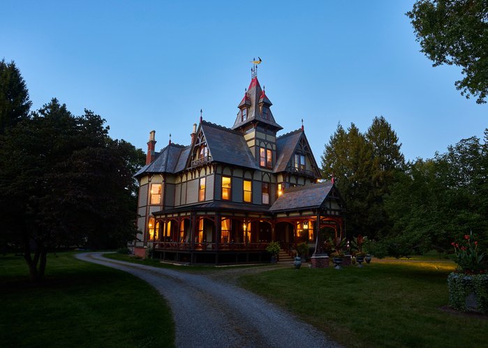 A Victorian House, The Pines Inn in Hudson Valley, glowing at Dusk.