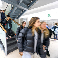 students blurred in hallway