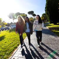 Three students walk outside