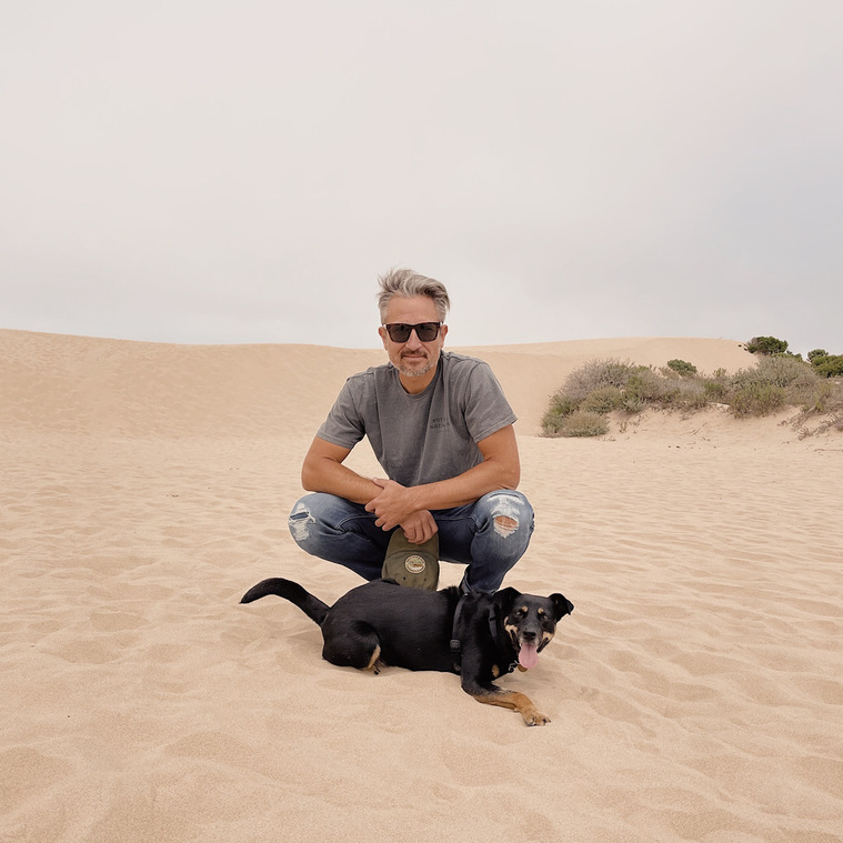 Photographer Robbie Bruzus and his dog Toro at the Oceano Dunes near San Luis Obispo, California.