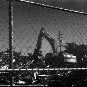 A gritty shot of the construction sites excavator pit in motion. 