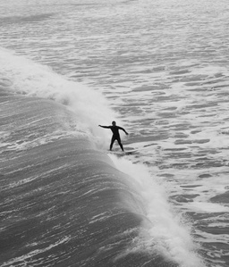 A surfer riding a wave in ocean beach san Diego. 