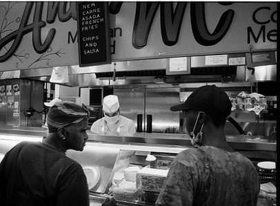 Women are looking at each other in front of the restaurant in Los Angeles Grand Central Market.  