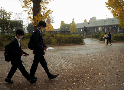 Two groups of people walking with completely different purposes. 