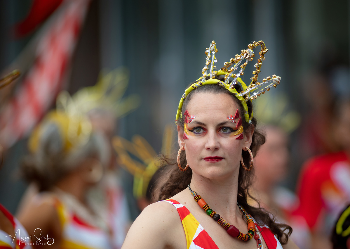 Wellington Batucada lead female dancer in full costume gazing into the distance shot by Nigel Sloley Photography at New Zealand's Cuba Dupa Street carnival in Wellington.