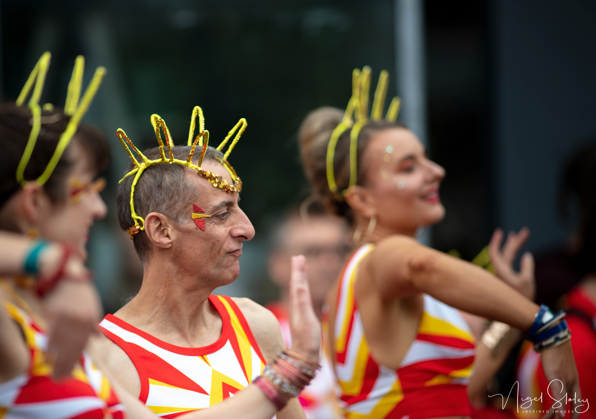 Wellington Batucada male dancer in full costume dancing in the street shot by Nigel Sloley Photography at New Zealand's Cuba Dupa Street carnival in Wellington.