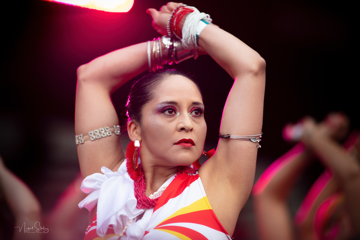 Wellington Batucada female dancer in full costume with strong gaze into the distance shot by Nigel Sloley Photography at New Zealand's Cuba Dupa Street carnival in Wellington.