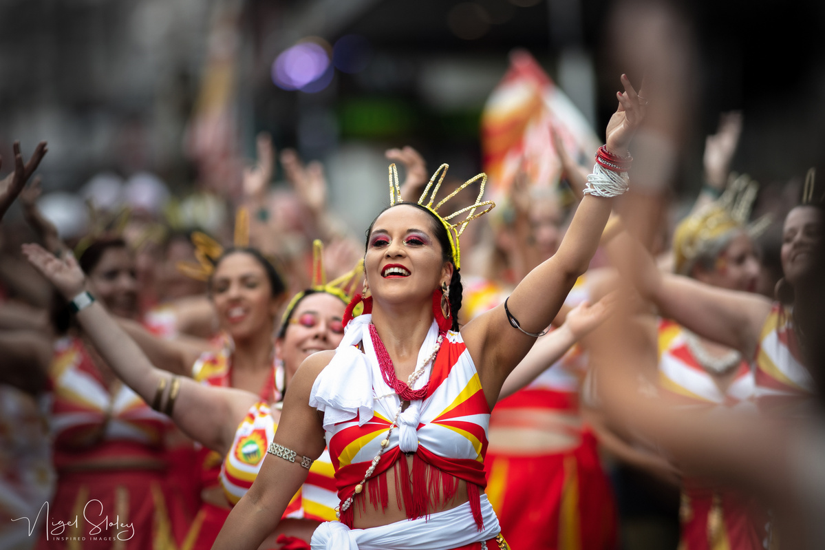 Wellington Batucada lead female dancer in full costume dancing in the street shot by Nigel Sloley Photography at New Zealand's Cuba Dupa Street carnival in Wellington.