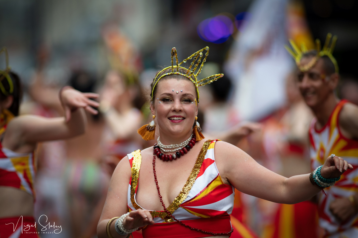 Wellington Batucada lead female dancer in full costume dancing in the street shot by Nigel Sloley Photography at New Zealand's Cuba Dupa Street carnival in Wellington.