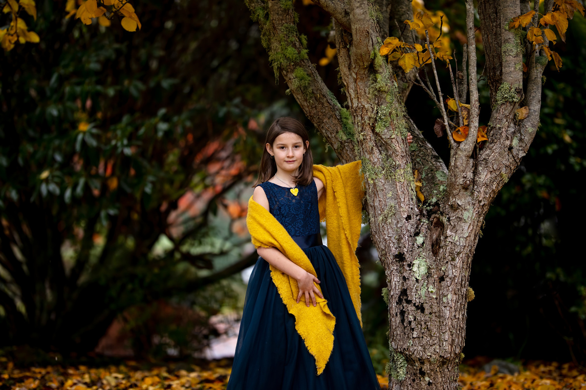 Jacqueline wrapped in a yellow shawl and wearing a blue gown with yellow Hearts and Roses necklace shot by Nigel Sloley Photography.