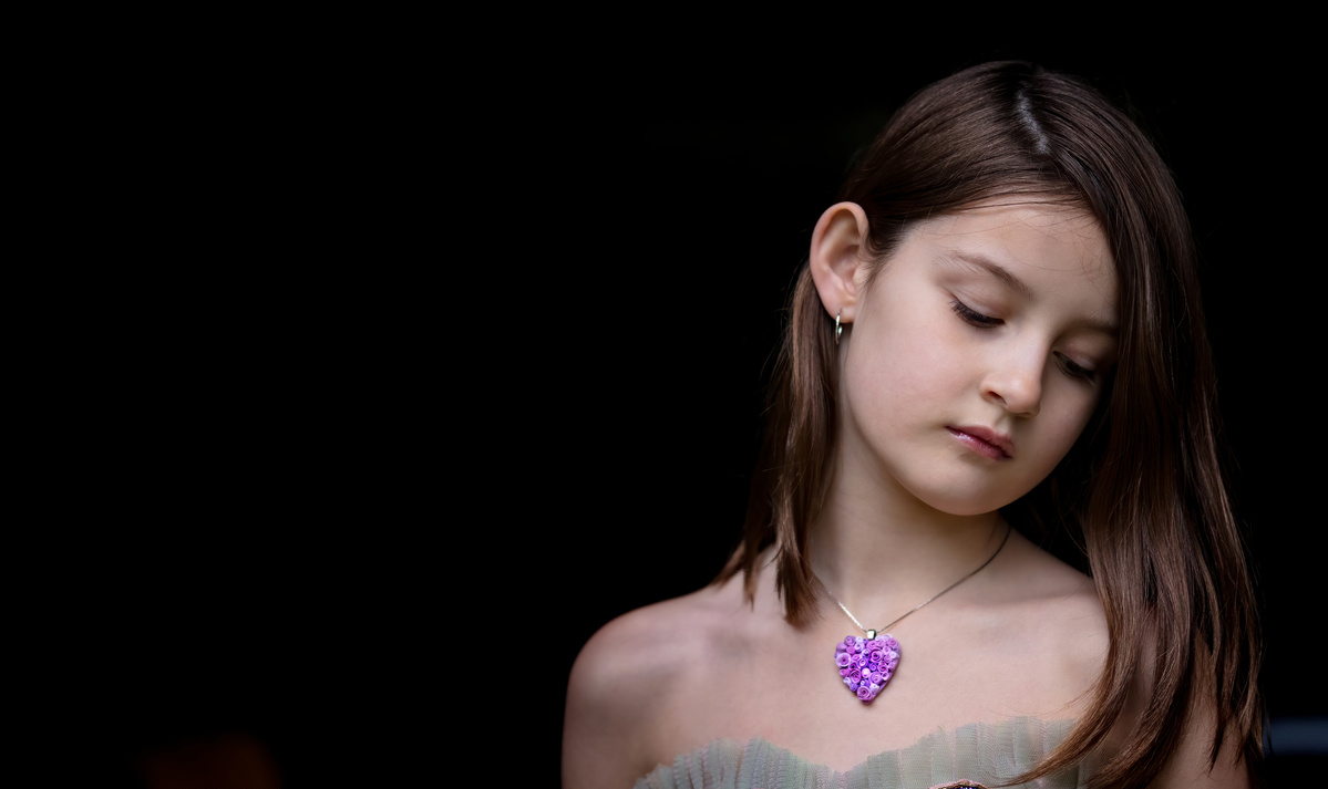Portrait of Jacqueline wearing a mauve Hearts and Roses necklace, Jewelry shot by Nigel Sloley Photography.