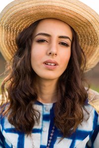close up stylized portrait of a farm girl wearing a cowboy hat during sunset posing confidently for the camera shot by leading jewellery photographer based in pune india