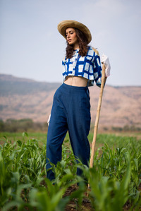 girl standing in the farmland and catering to crops in a creative concept photoshoot for a leading jewelry brand campaign by one of the most creative jewelry photographer based in pune india