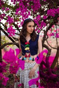 flowering pink portrait of girl standing in between beautiful plants during sunset shot by best advertising photographer based in mumbai india