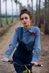 close up portrait of a girl on her farmland riding a cycle outdoor campaign shoot by top lifestyle photographer based in mumbai india
