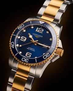 shooting a gold Longines luxury watch with a golden glow on the background in studio lighting setup by the best watch photographer based in Pune India