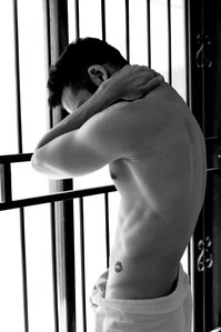 black and white man standing by the window staring in camera shot by top Indian advertising photographer in india 