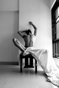 black and white portrait series of model posing on chair shot by top Indian commercial photographer based in mumbai india