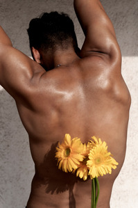 male model flexing back with yellow flowers concept shoot by best Indian advertising photographer based in pune india