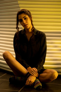 model sitting in front of graphic background golden yellow light shot by best indian advertising photographer based in mumbai india