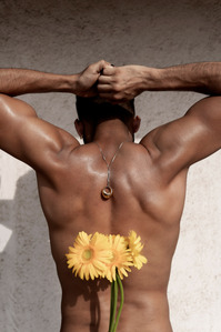 male model flexing back with yellow flowers concept shoot by best Indian lifestyle photographer based in mumbai india 