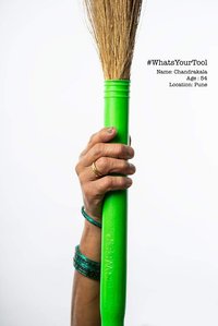 a house maid holds up a broom in as her tool of price in a photoshoot by indias best fashion photographer in mumbai