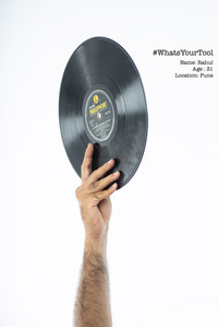 A disc jokey holding up an antique disc as his tool of choice for a conceptual photography shoot by best indian fashion and advertising photographer based in mumbai india