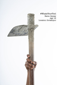 a cement layer construction worker holds up his professional tool of choice concept photoshoot by best fashion photographer in  mumbai india
