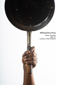 a cook holds up a frying pan as his professional tool of choice and his pride and honour photoshoot by leading commercial photographer based in mumbai india