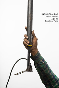 a tyre puncture repair guys holding his air pump as his preferred tool of choice concept photoshoot series by leading indian fashion photographer based in mumbai india