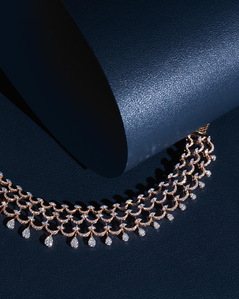 a stunning diamond necklace photographed on crisp blue background for a best jewellery branding photographer based in Pune India