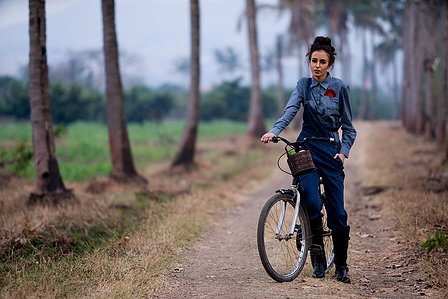 farm girl heidi on traditional cycle standing by the farm roads during sunset photoshoot by leading lifestyle conceptual photographer based in pune india
