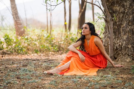 girl sitting under tree wearing orange designer gown shot by by ashish gurbani  top fashion and advertising photographer in santacruz east mumbai and pune india