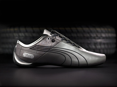 a conceptual product photograph of a grey puma shoe in studio set up with black background shot by top product photographer ashish gurbani based in pune maharashtra india