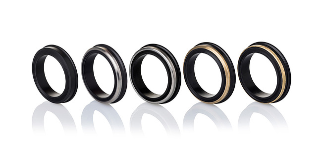 a professional photoshoot of black metal rings shot in studio setup with a white background by leading still life photographer ashish gurbani based in mumbai india
