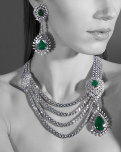 an emerald stuff jewellery set photographed in a photo studio setup for a conceptual campaign photoshoot