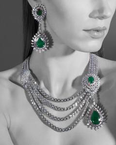 an emerald stuff jewellery set photographed in a photo studio setup for a conceptual campaign photoshoot