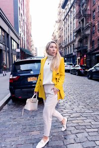 professional photo shot in portrait mode of a female model walking on the streets of new york with cars and buildings in the background taken by best advertising photographer ashish gurbani based in pune india