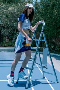 beautiful model posing with ladder on tennis court concept photoshoot with best fashion photographer based in mumbai india