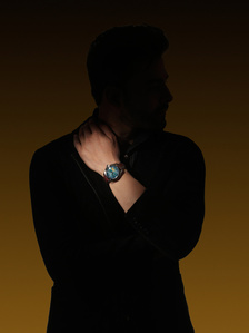 a male hand model poses with a luxury watch in conceptual lighting in a photography studio in mumbai