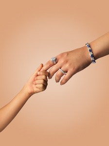 a child holds her mothers hand for a mothers day lifestyle photography in india