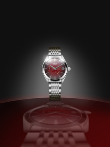 photographer captures red luxury watch by argos on a metal brushed orbit top for  conceptual product shoot in pune india
