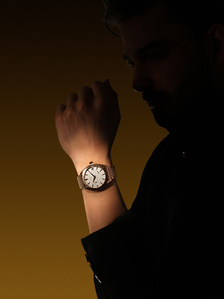 a male model poses in silhouette lighting with a luxury watch product photography pune