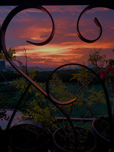 a beautiful professional sunset shot through a metal grill during sunset with a purple sky in a  wallpaper frame setting photographed by top advertising photographer ashish gurbani based in pune india