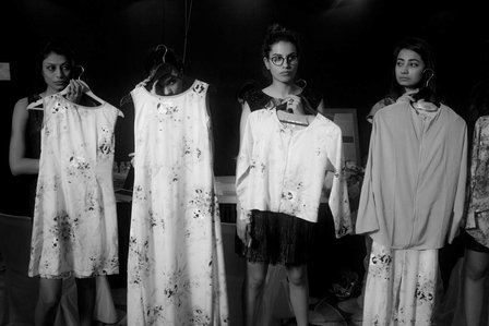 a backstage series professionally taken in black and white of four women holding up clothes in a candid shot taken by leading fashion photographer ashish gurbani based in pune india