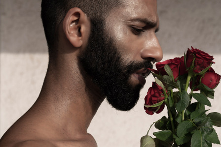 male model smelling red rose flower shoot by top Indian fashion photographer based in pune india