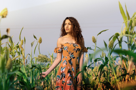 aleena Mackar the style chair blogger walking past beautiful fields during sunrise shot by best indian advertising photographer based in mumbai india